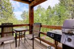 Deck with gas BBQ grill and table with chairs